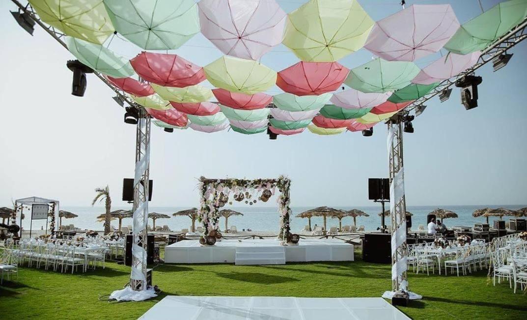 Borg El Arab Beach Resort Exteriör bild A canopy of umbrellas